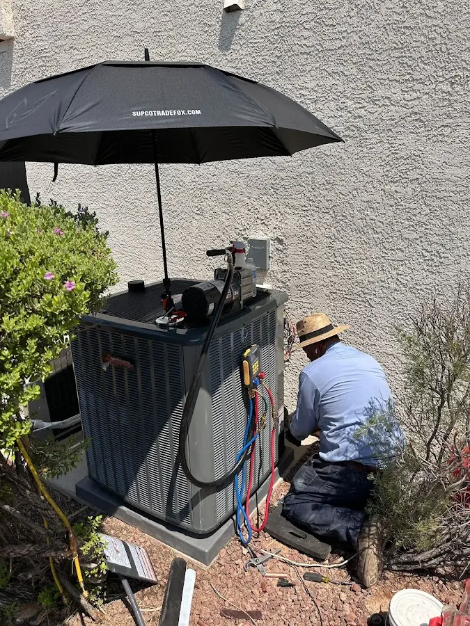 HVAC technician performing outdoor AC maintenance in Cortland